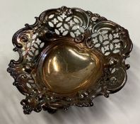 A small heart-shaped silver pin dish.