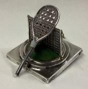 An unusual novelty silver pin cushion in the form of a tennis racket on rectangular base.