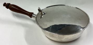 An unusual Sterling silver hinged top brandy pan with turned handle.