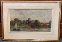 A framed and glazed watercolour depicting a river scene with boat and swans by a village.