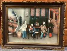 CHINESE SCHOOL: A gilt framed reverse painted oil on glass depicting Oriental figures.