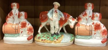A group of three Staffordshire figures.