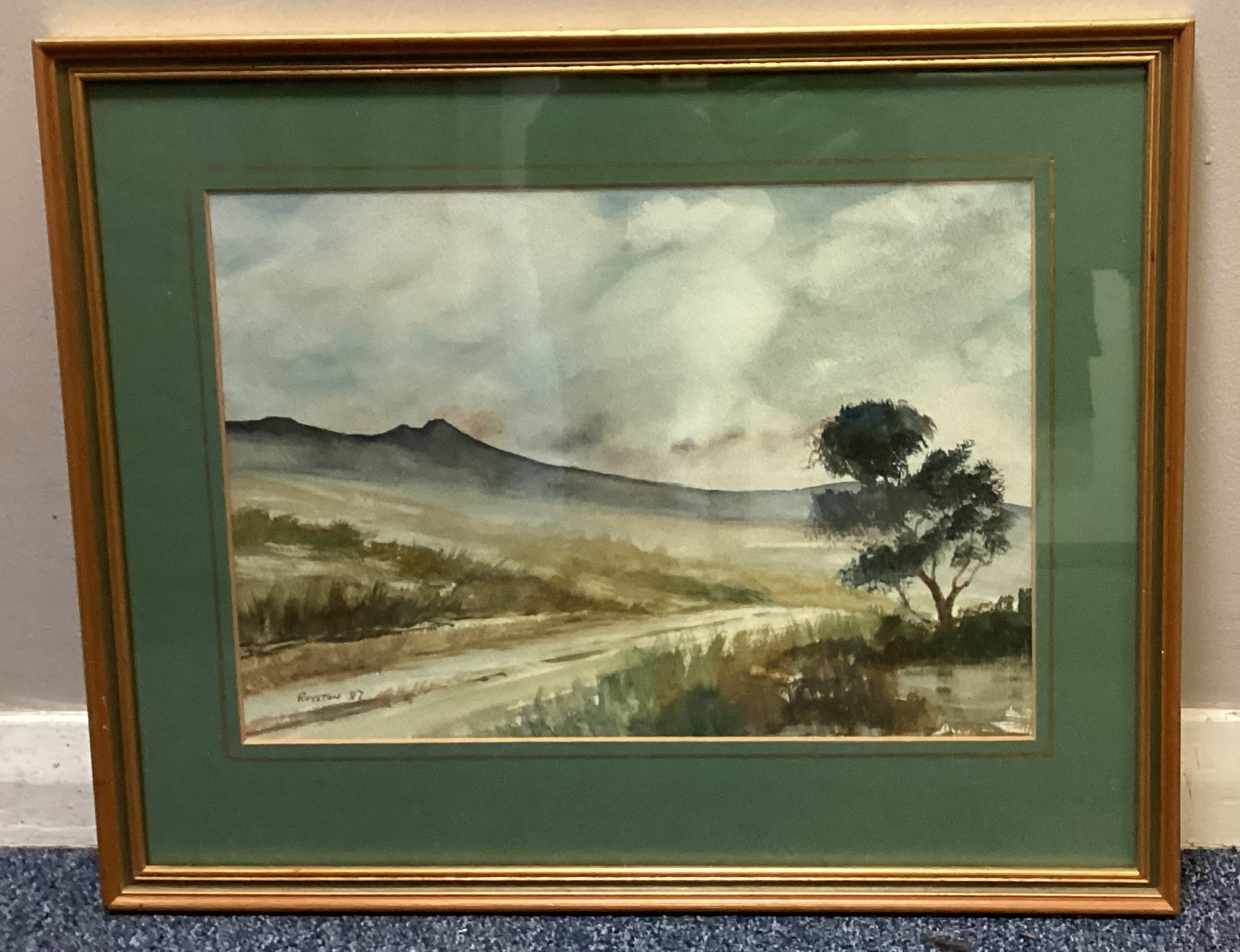 A gilt framed and glazed watercolour depicting a typical Dartmoor Tor scene.