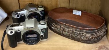 Two Canon cameras together with a leather basket.