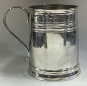 A Queen Anne Britannia Standard silver mug with reeded decoration.
