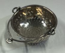 A French silver tea strainer.