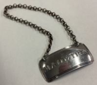 A large 19th Century silver wine label for 'Madeira'.