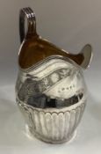 A fine Georgian silver cream jug with bright-cut decoration.