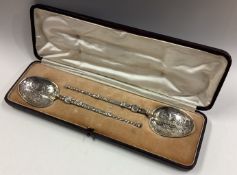 A large pair of commemorative silver spoons.