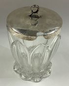 A silver and glass honey jar.