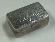 An engraved silver pill box bearing import marks.