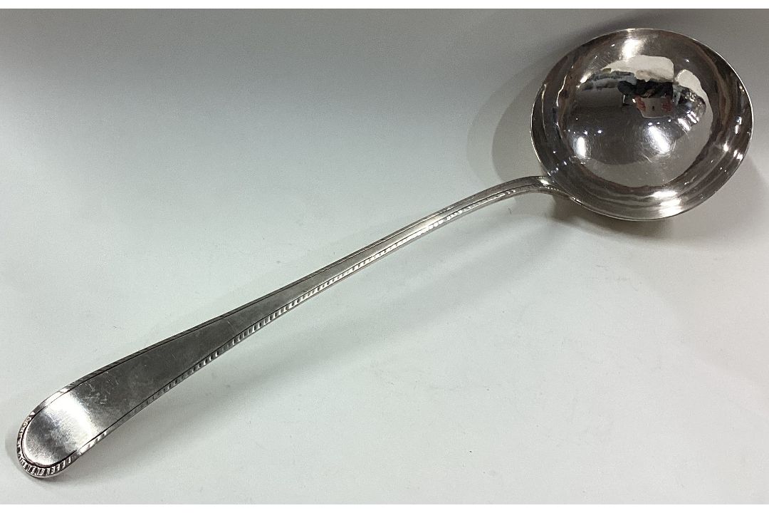 An 18th Century silver bottom marked soup ladle. - Image 1 of 2