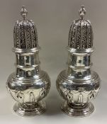 A fine and heavy pair of George II silver casters of good gauge.