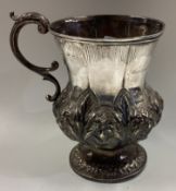 DUBLIN: An Irish Georgian silver mug with chased decoration.