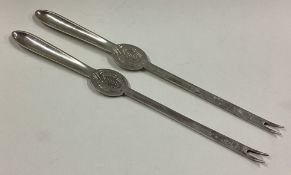 A pair of silver lobster picks.