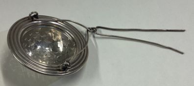 A French silver tea strainer.