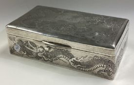 A Chinese export silver cigar box engraved with dragons.