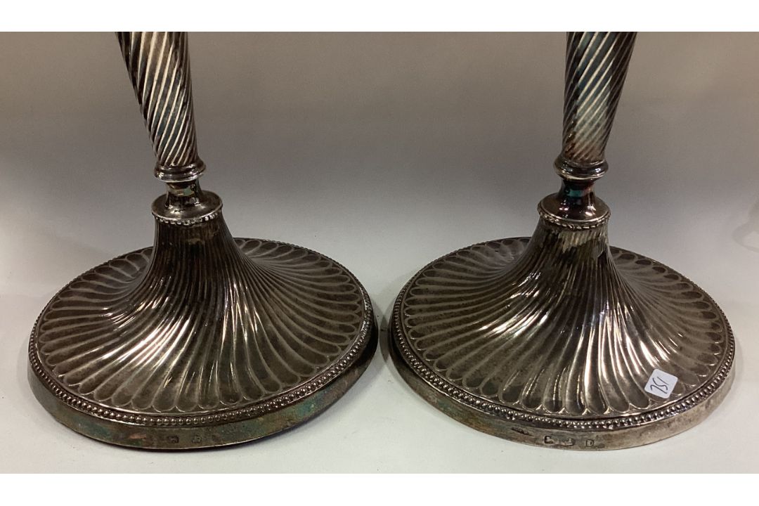 A large pair of 18th Century Georgian silver candlesticks with swirl fluting. - Image 2 of 2