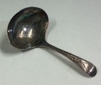 An 18th Century George III silver caddy spoon with bright-cut decoration.