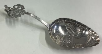 A Dutch silver caddy spoon with chased decoration.