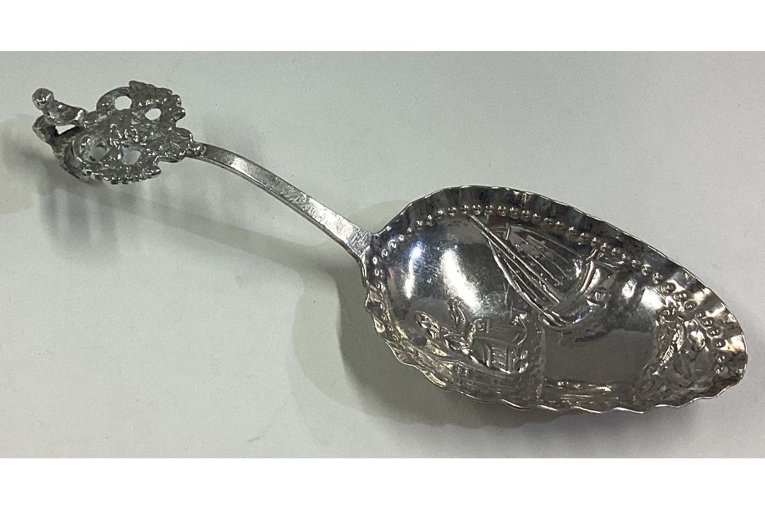 A Dutch silver caddy spoon with chased decoration. - Image 1 of 2