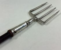 A large 19th Century Georgian silver toasting fork with wooden handle.