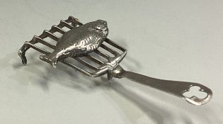 An 18th Century Dutch silver table toy in the form of a fish on server.