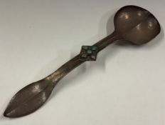 An Art Nouveau Continental silver spoon with stone set terminal.
