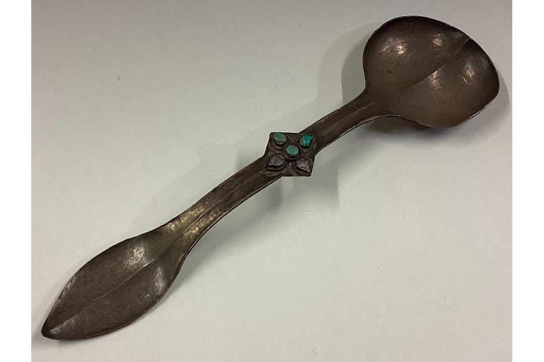 An Art Nouveau Continental silver spoon with stone set terminal.
