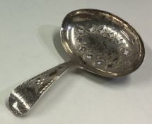 An 18th Century George III silver caddy spoon with pierced and bright-cut decoration.