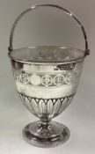 A pierced silver swing handled basket with glass liner in the Georgian style.