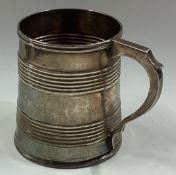 A Georgian silver mug with reeded decoration.