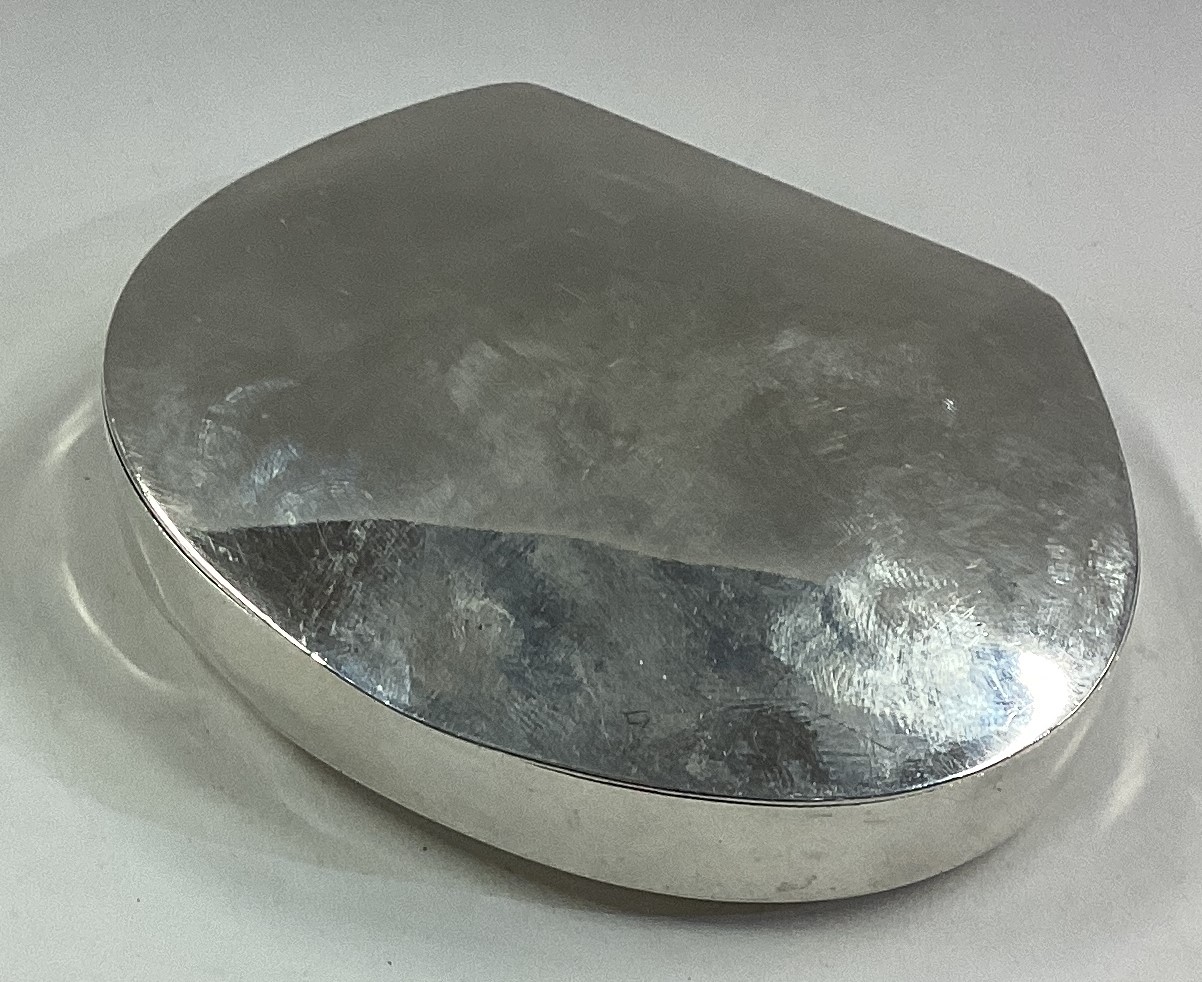 A shaped plain silver snuff box.