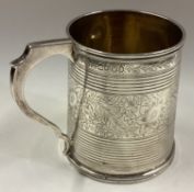 A Georgian silver mug with bright-cut decoration.