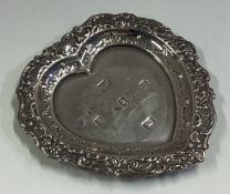 A heart-shaped silver dish with chased border.