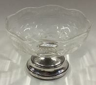 A silver and glass ice cream dish.