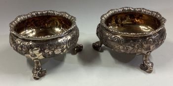 A pair of 18th Century silver salt cellars with chased decoration.