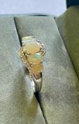 An Ethiopian Opal & White Topaz Ring With Valuation