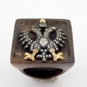 An Exquisite Eagle Ebony Ring Detailed With Brilliant Diamonds and Gold On Silver.