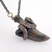 A Shark Tooth Necklace Detailed With Brilliant Diamonds and Gold On Silver.