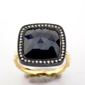 An Exquisite Gold Ring Detailed With Slice Cut Rough Sapphire In The Centre and Brilliant Diamon...