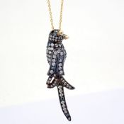An exquisite bird necklace detailed with brilliant diamonds and gold on silver