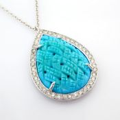 An exquisite necklace detailed with special carved turquoise, brilliant diamonds and gold