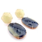 An exquisite gold earrings detailed with slice cut rough sapphire in the centre