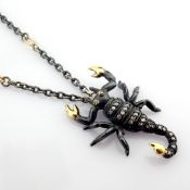 An exquisite scorpion necklace detailed with brilliant diamonds and gold on silver.