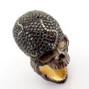 Hand-made skull ring detailed with brilliant diamonds and gold on silver.