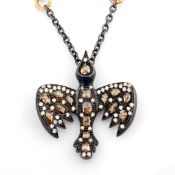 An exquisite bird necklace detailed with brilliant diamonds and gold on silver