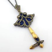 Key necklace detailed with brilliant diamonds, lapis-lazuli powder and 14k, 24k gold on silver.