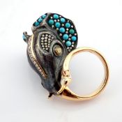 An exquisite elephant ring detailed with turquoise. brilliant diamonds and gold on silver.
