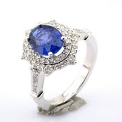 An exquisite 18k white gold cluster ring detailed with sapphire and brilliant diamonds